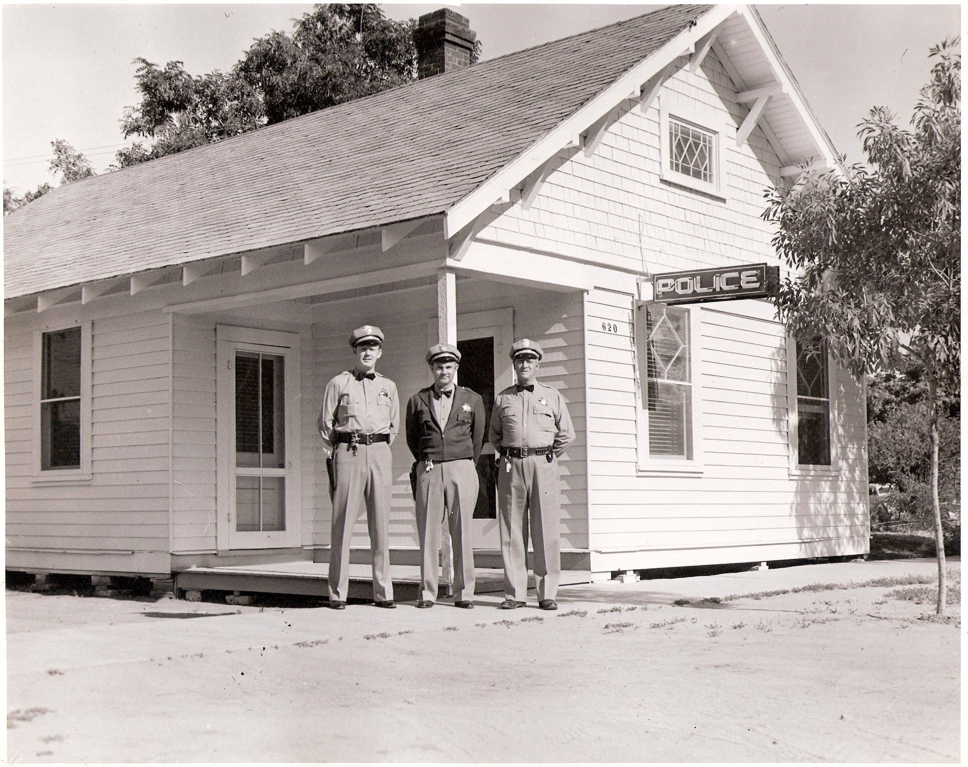 Chief Triplett and Officers in front of the old Police Station at 2948 Fourth St